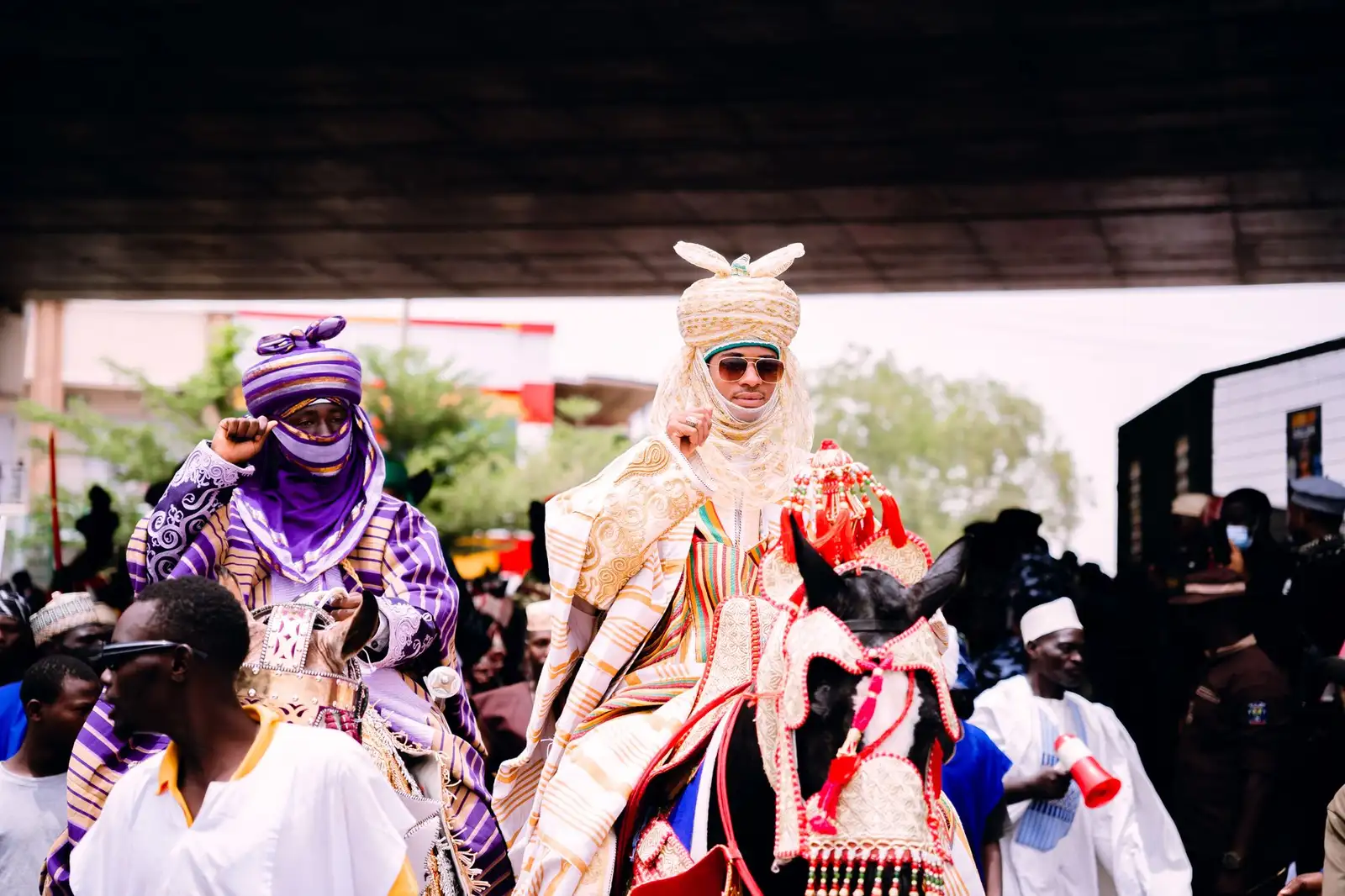 Vibrant celebration of Nigerian culture at the Durbar festival, featuring colorful attire and horses.