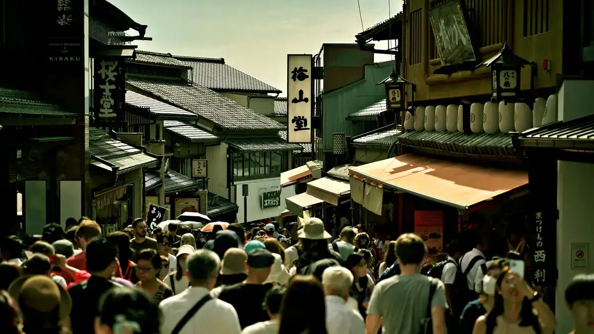Busy pedestrian street in Kyoto, Japan, showcasing traditional architecture and vibrant life.